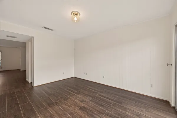 a view of a room with wooden floor