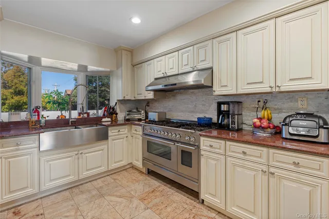 a kitchen with stainless steel appliances granite countertop a stove and cabinets