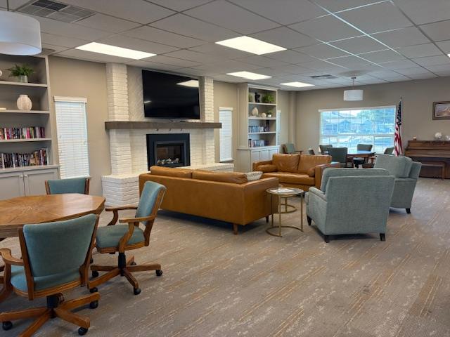 500 North Tully Road, Unit 110 Turlock, CA 95380 - Photo 15 of 17 a living room with furniture a flat screen tv and a fireplace