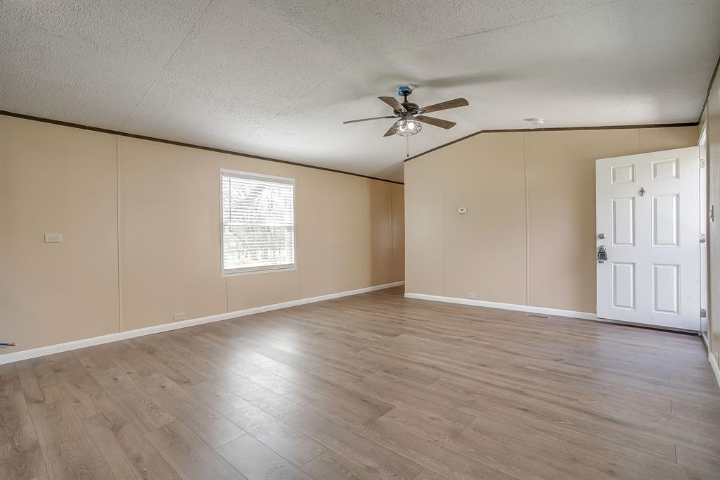 1948 Lariat Lane Burleson, TX 76028 - Photo 9 of 36 a view of empty room with wooden floor and fan