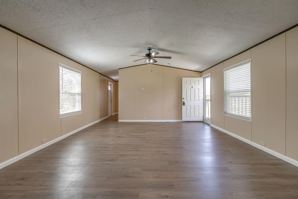 1948 Lariat Lane Burleson, TX 76028 - Photo 10 of 36 an empty room with wooden floor and windows