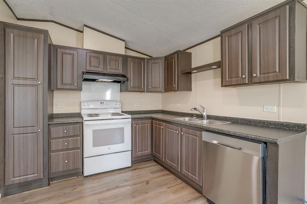 1948 Lariat Lane Burleson, TX 76028 - Photo 11 of 36 a kitchen with stainless steel appliances granite countertop a sink stove and refrigerator