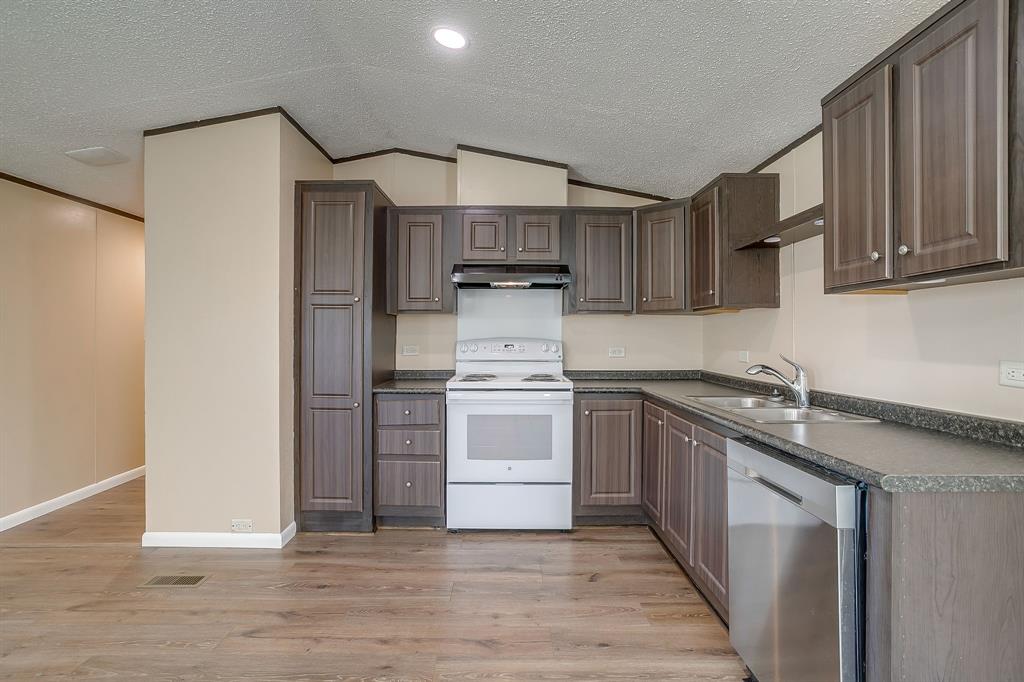 1948 Lariat Lane Burleson, TX 76028 - Photo 12 of 36 a kitchen with stainless steel appliances granite countertop a stove and a sink