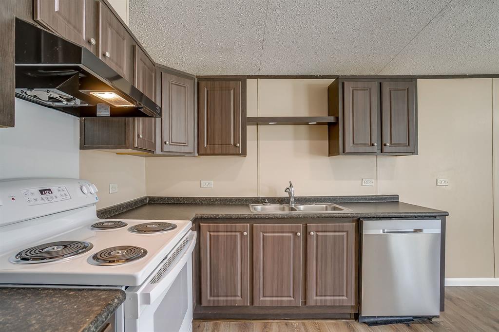 1948 Lariat Lane Burleson, TX 76028 - Photo 13 of 36 a kitchen with stainless steel appliances granite countertop a sink stove and cabinets