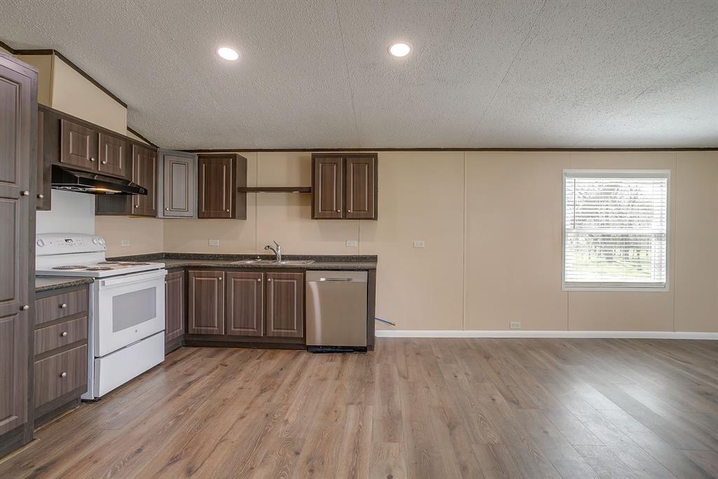 1948 Lariat Lane Burleson, TX 76028 - Photo 14 of 36 a kitchen with stainless steel appliances granite countertop a stove a sink and a refrigerator