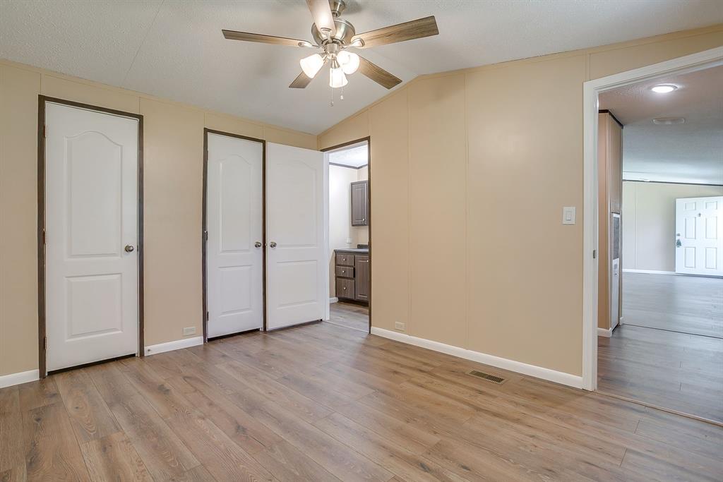 1948 Lariat Lane Burleson, TX 76028 - Photo 16 of 36 an empty room with wooden floor and a ceiling fan