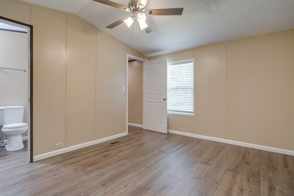 1948 Lariat Lane Burleson, TX 76028 - Photo 17 of 36 a view of an empty room with wooden floor and a window