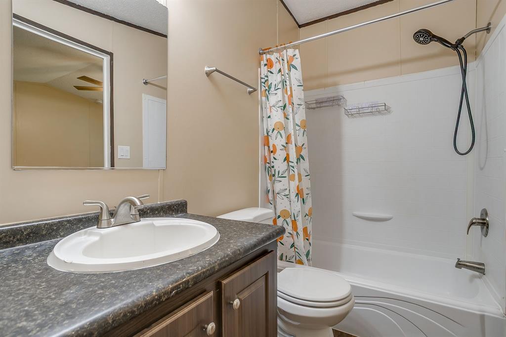 1948 Lariat Lane Burleson, TX 76028 - Photo 18 of 36 a bathroom with a granite countertop sink toilet and shower
