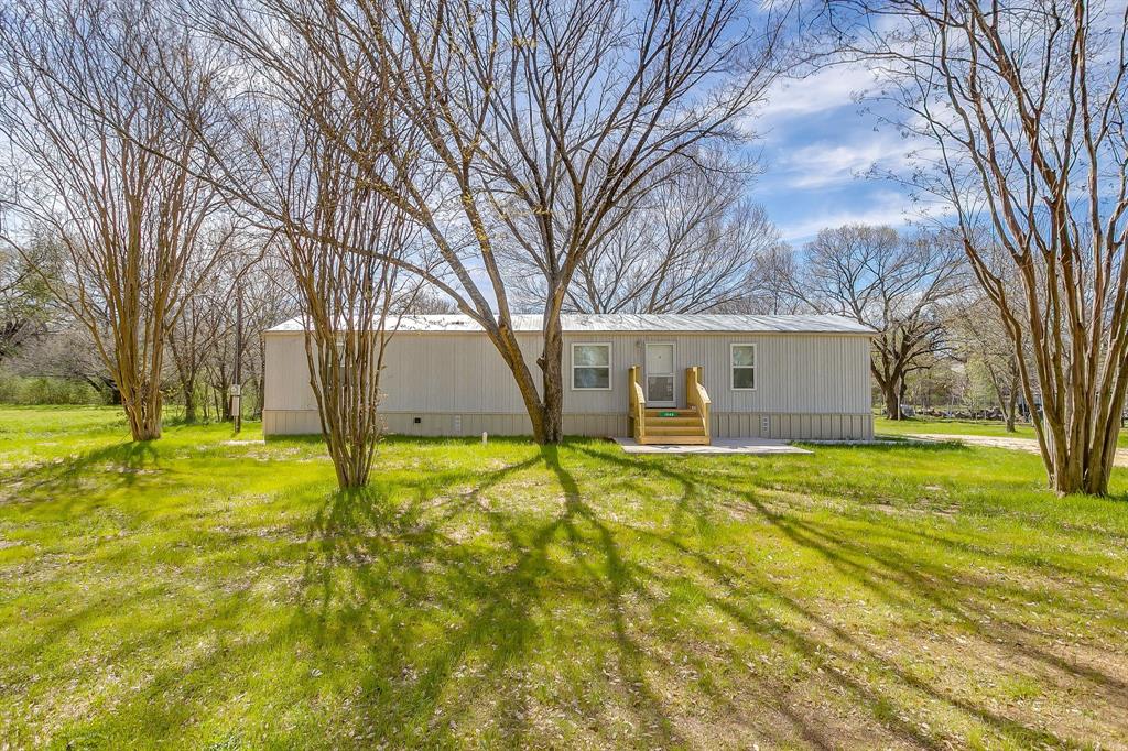 1948 Lariat Lane Burleson, TX 76028 - Photo 2 of 36 a view of swimming pool and trees in the background