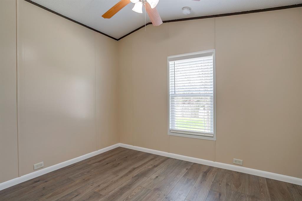 1948 Lariat Lane Burleson, TX 76028 - Photo 22 of 36 an empty room with wooden floor and windows