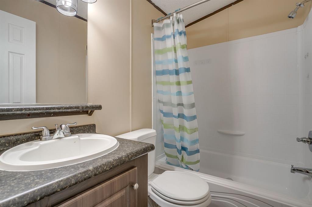 1948 Lariat Lane Burleson, TX 76028 - Photo 23 of 36 a bathroom with a sink toilet and shower