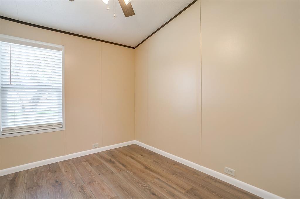 1948 Lariat Lane Burleson, TX 76028 - Photo 24 of 36 a view of an empty room with wooden floor and a window