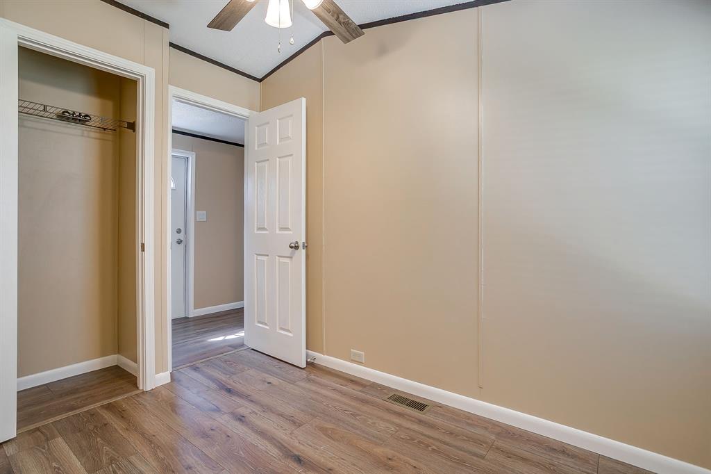 1948 Lariat Lane Burleson, TX 76028 - Photo 26 of 36 a view of an empty room with wooden floor and a ceiling fan