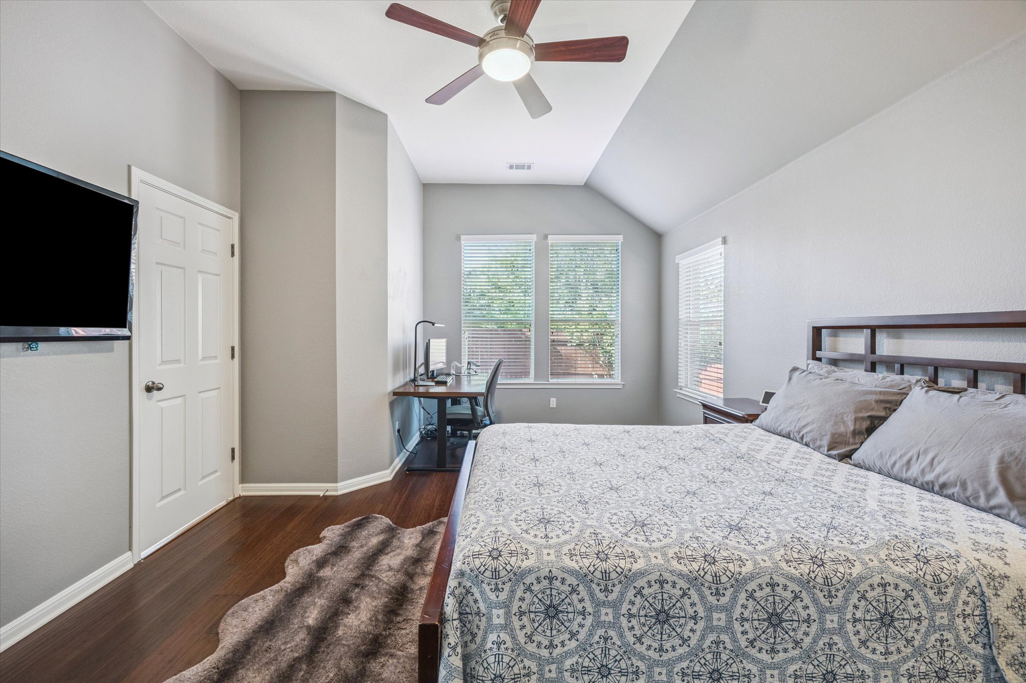 1427 Gorham Street Austin, TX 78758 - Photo 12 of 20 a bedroom with a bed and a flat screen tv