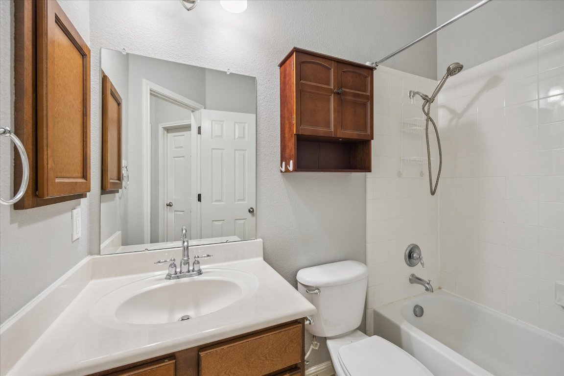 1427 Gorham Street Austin, TX 78758 - Photo 14 of 20 Bathroom with vanity, tub / shower combination, and a textured wall