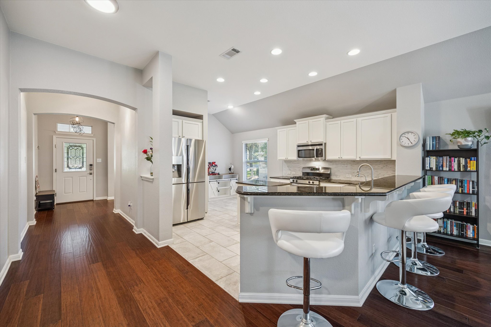 1427 Gorham Street Austin, TX 78758 - Photo 5 of 20 a kitchen with stainless steel appliances granite countertop a table chairs refrigerator and sink