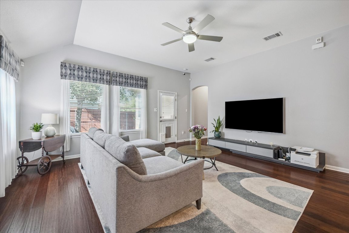 1427 Gorham Street Austin, TX 78758 - Photo 6 of 20 Living room featuring dark wood finished floors, arched walkways, and ceiling fan