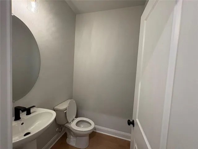 a white toilet sitting next to a bathroom sink