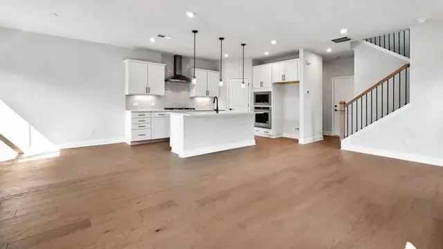 a kitchen with white cabinets and refrigerator