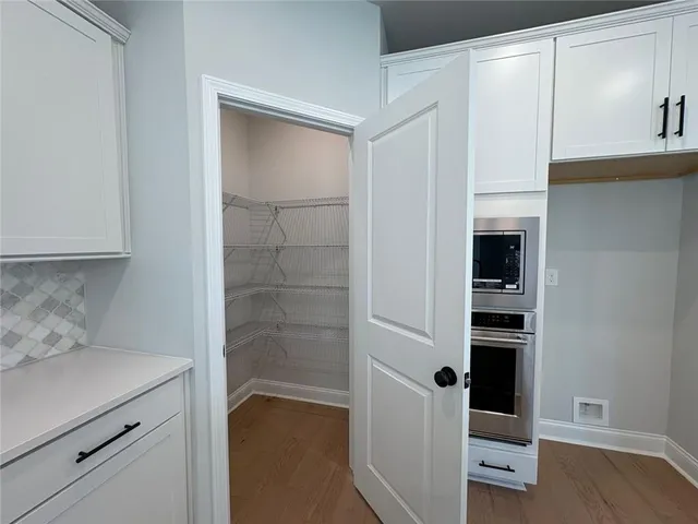 a kitchen with a refrigerator and cabinets
