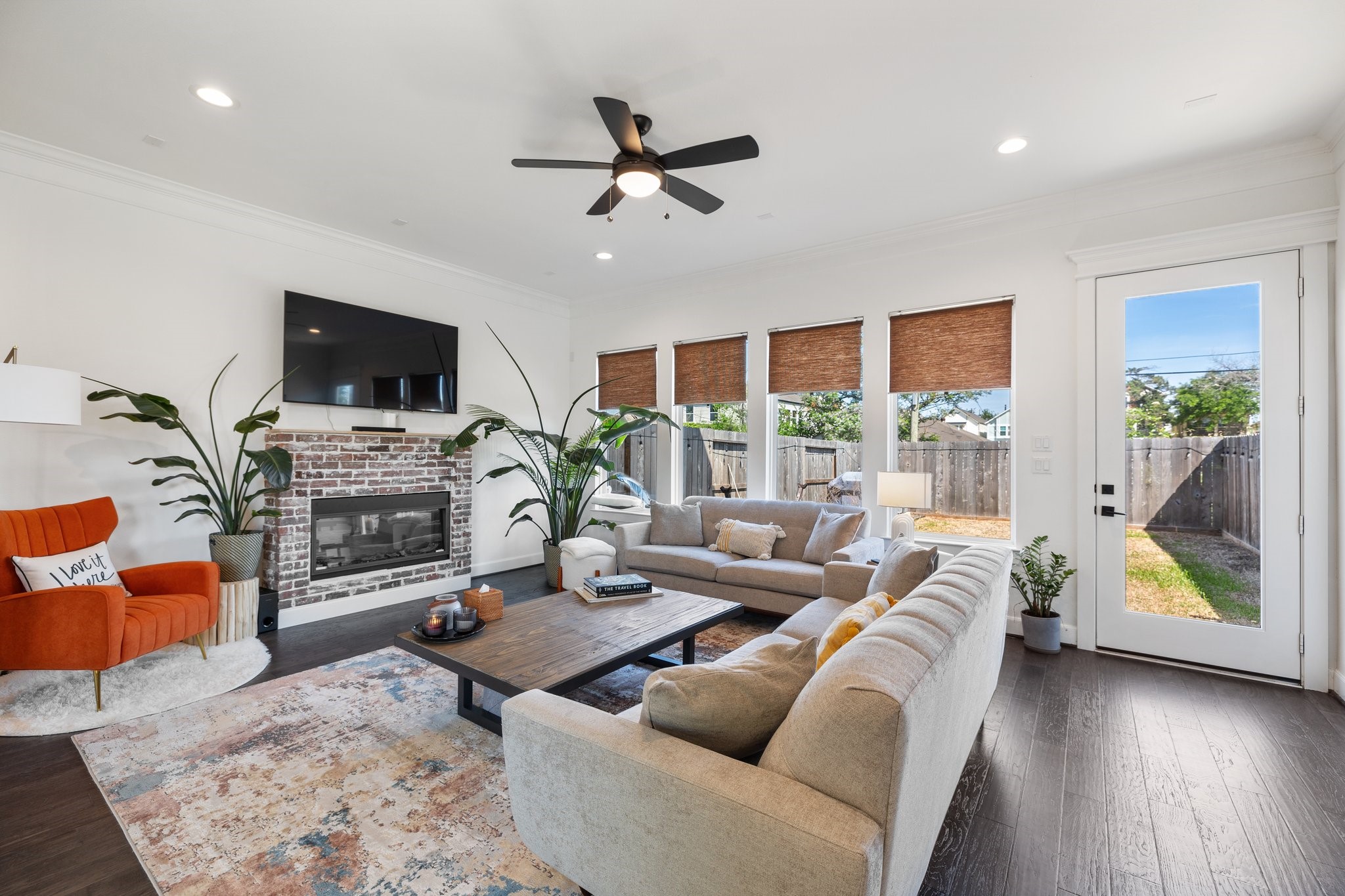 817 West 19th Street Houston, TX 77008 - Photo 10 of 24 An electric fireplace with faux brick surround is the focal point of this inviting living space.