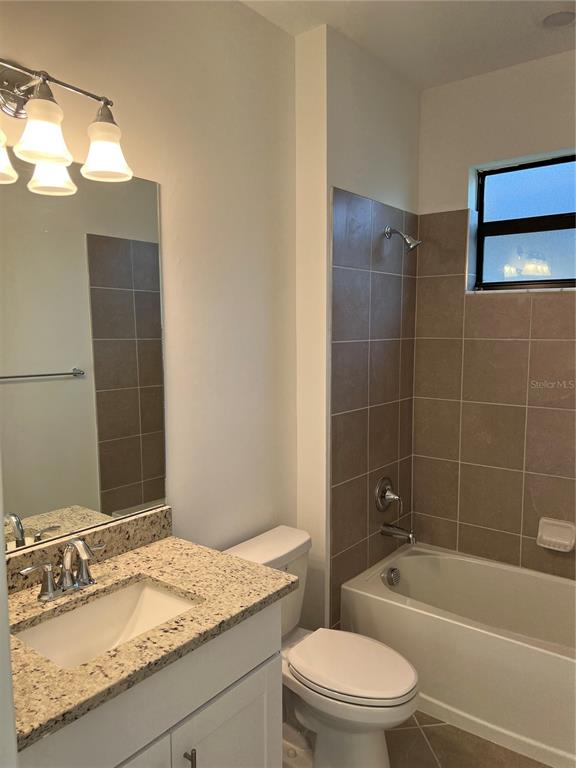 19524 Fishhawk Trail Venice, FL 34293 - Photo 13 of 30 a bathroom with a granite countertop sink a toilet and bathtub