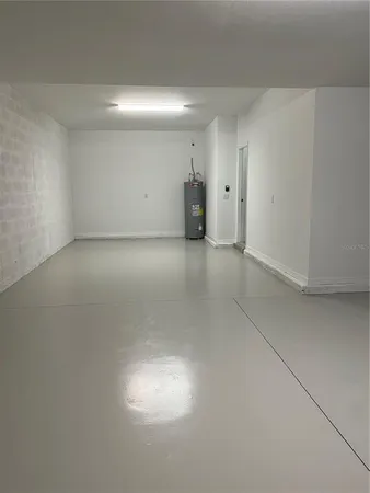 a kitchen with a sink and wooden floor