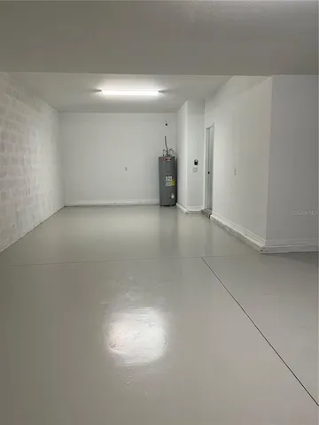 a kitchen with a sink and wooden floor