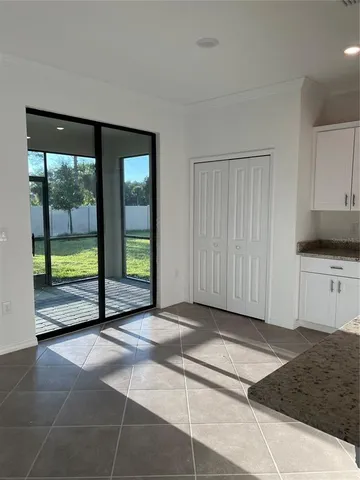 a kitchen with stainless steel appliances granite countertop a sink a stove a refrigerator and cabinets