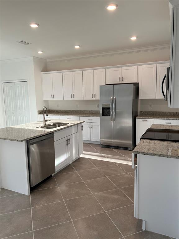 19524 Fishhawk Trail Venice, FL 34293 - Photo 20 of 30 a kitchen with stainless steel appliances granite countertop a sink a stove a refrigerator and cabinets