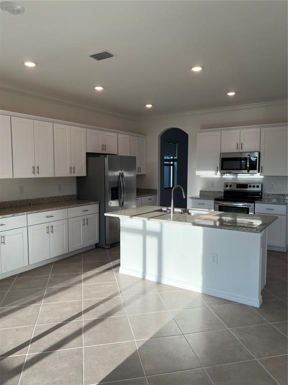 19524 Fishhawk Trail Venice, FL 34293 - Photo 21 of 30 a kitchen with stainless steel appliances granite countertop a sink a stove top oven and cabinets