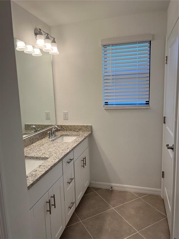 19524 Fishhawk Trail Venice, FL 34293 - Photo 25 of 30 a bathroom with a granite countertop sink and a mirror