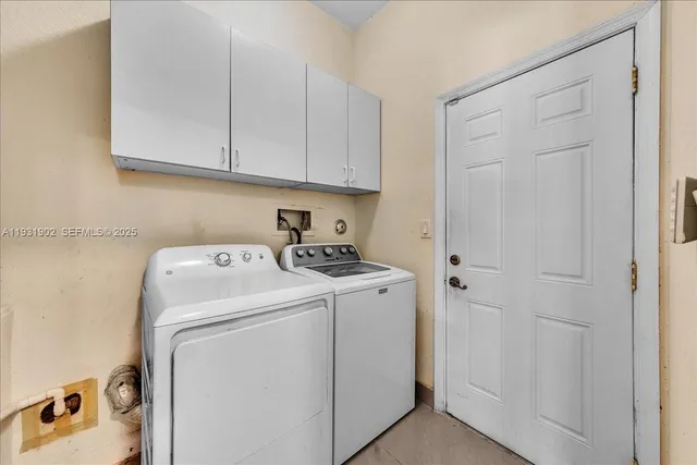 a view of an empty room with wooden floor and a ceiling fan