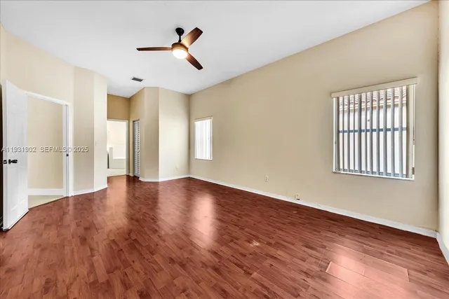 a bathroom with a granite countertop double vanity sink and mirror