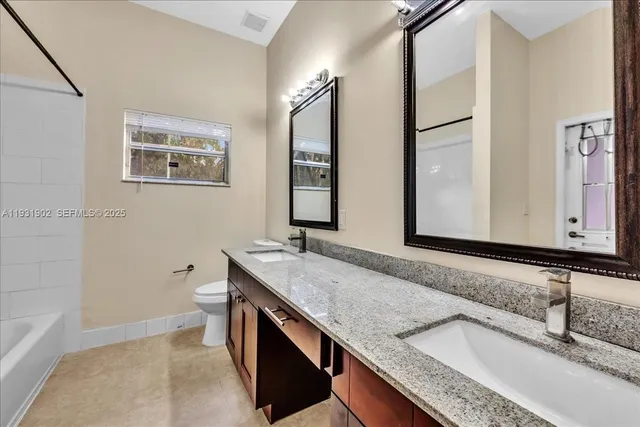 an aerial view of house with yard swimming pool and outdoor seating