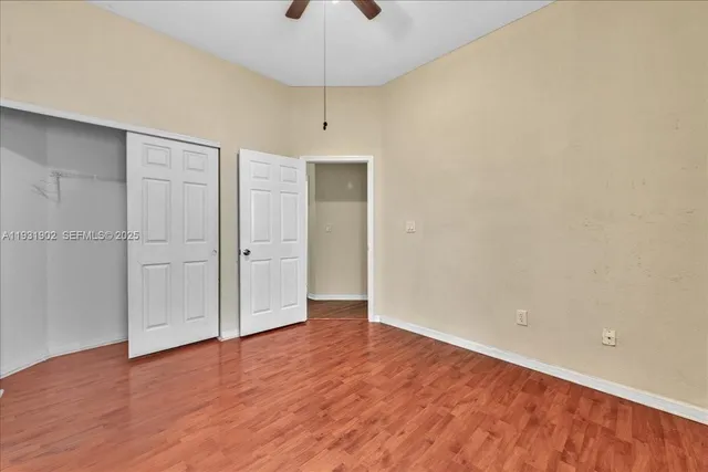 a view of a house with a big yard and large trees