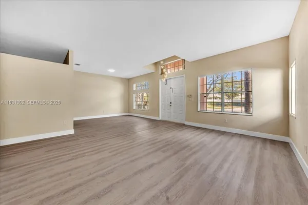 a kitchen with granite countertop white cabinets stainless steel appliances and a sink