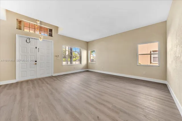 a kitchen with granite countertop a refrigerator and a sink