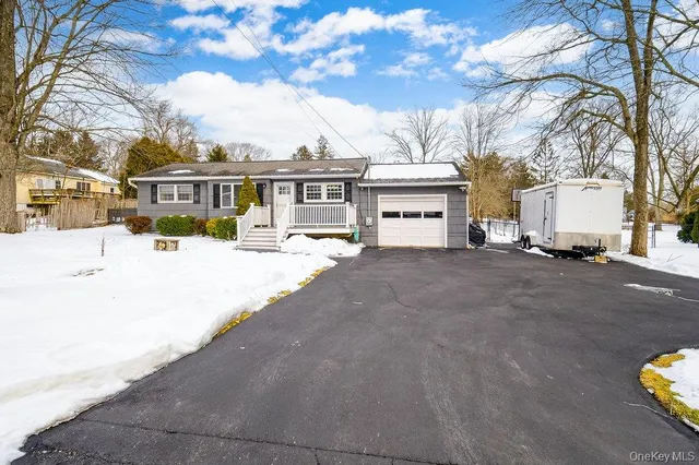 a view of a house with a snow in the background