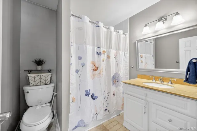 a bathroom with a toilet a sink and a shower