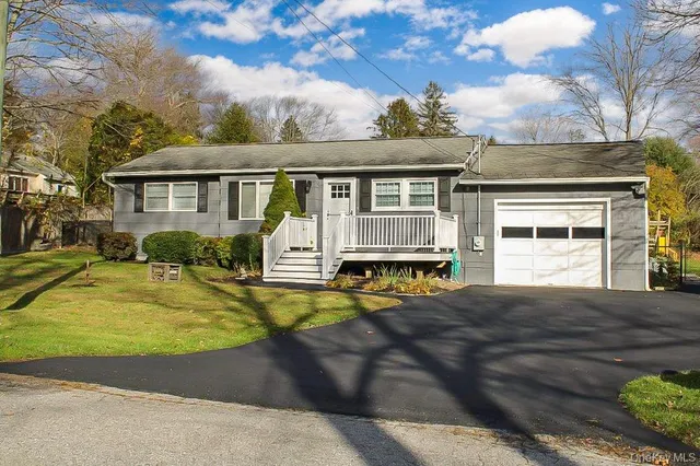 a view of a house with pool and chairs