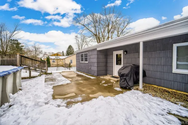 a view of a backyard with wooden fence