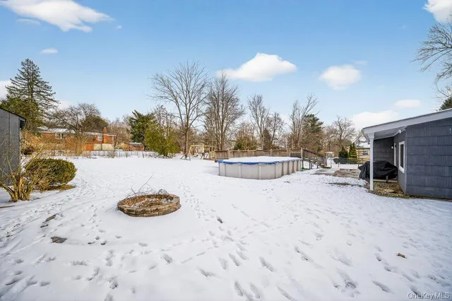 a view of swimming pool with outdoor seating and plants