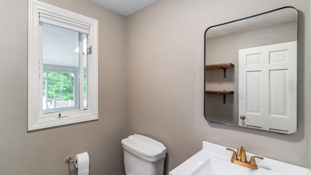 142 Baker Street Walpole, MA 02081 - Photo 14 of 42 a bathroom with a toilet a sink and mirror
