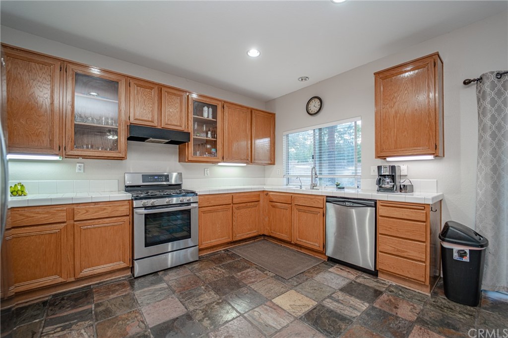 2810 Athens Circle Corona, CA 92882 - Photo 12 of 34 a kitchen with stainless steel appliances granite countertop a stove sink and cabinets