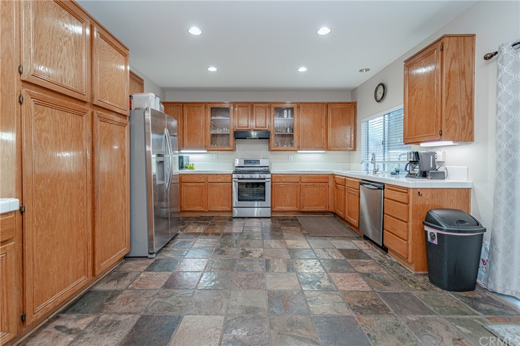 2810 Athens Circle Corona, CA 92882 - Photo 13 of 34 a large kitchen with stainless steel appliances granite countertop a sink and cabinets