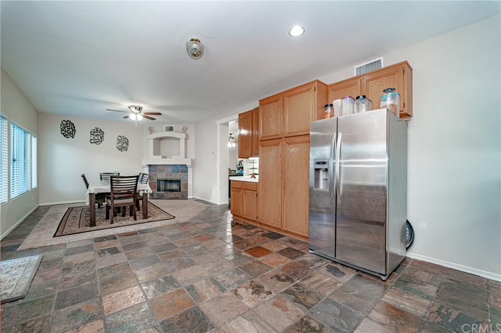 2810 Athens Circle Corona, CA 92882 - Photo 15 of 34 a dining room with furniture and a refrigerator