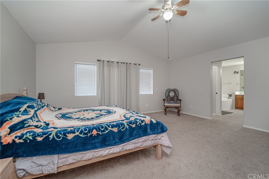 2810 Athens Circle Corona, CA 92882 - Photo 21 of 34 a bedroom with a bed and a chandelier