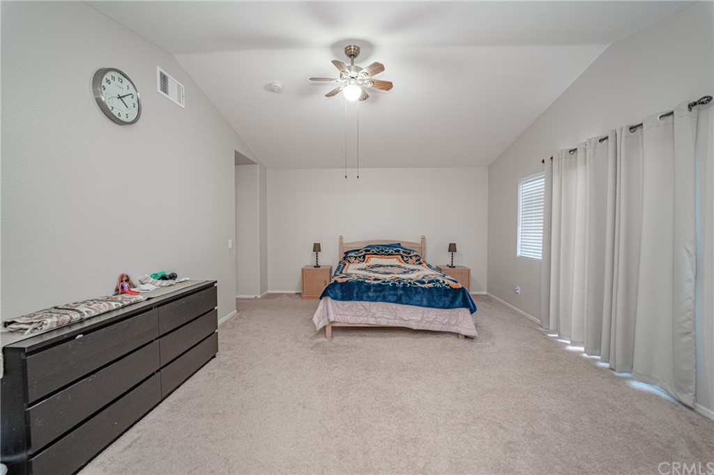 2810 Athens Circle Corona, CA 92882 - Photo 22 of 34 a bedroom with a bed and a chandelier