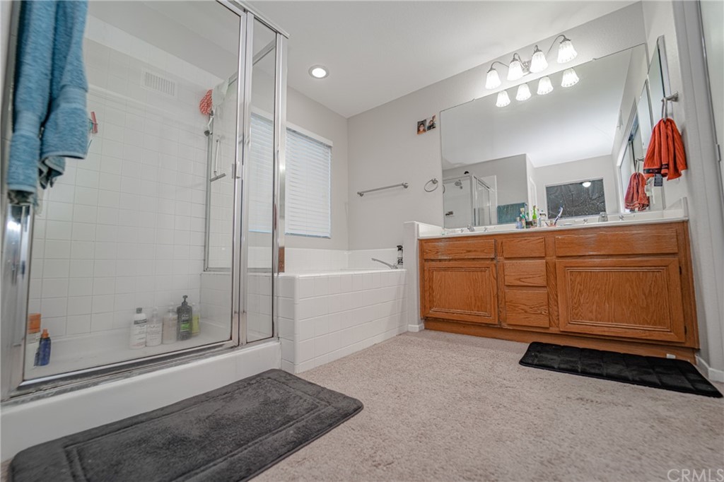 2810 Athens Circle Corona, CA 92882 - Photo 23 of 34 a spacious bathroom with a double vanity sink a mirror and a shower
